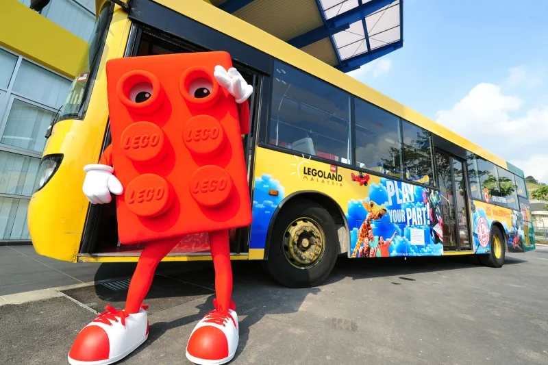 Bricky, the LEGOLAND Mascot with one of the new buses that will be serving LEGOLAND Malaysia v2