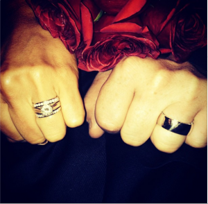The couple showing off their wedding rings