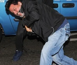 Kanye seen struggling for the camera with Daniel