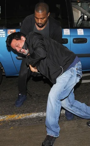 Kanye seen struggling for the camera with Daniel