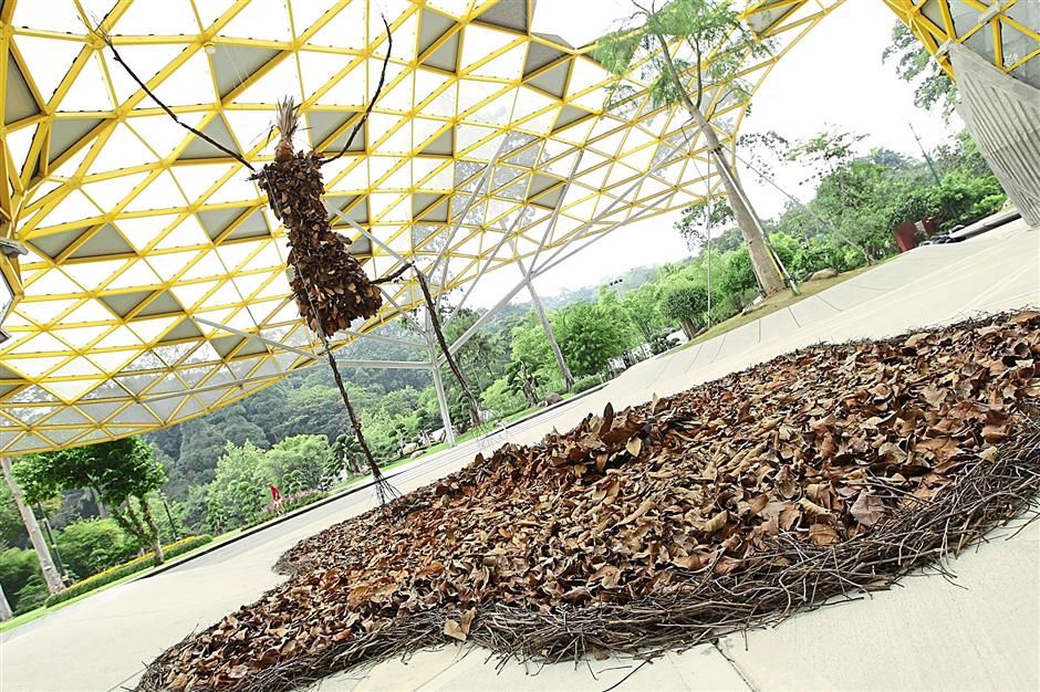 Walk In The Park by Lisa Foo towers at 15-ft and is a stickman made from leaves, twigs and branches collected at Lake Garden itself. (Source: Star Online)