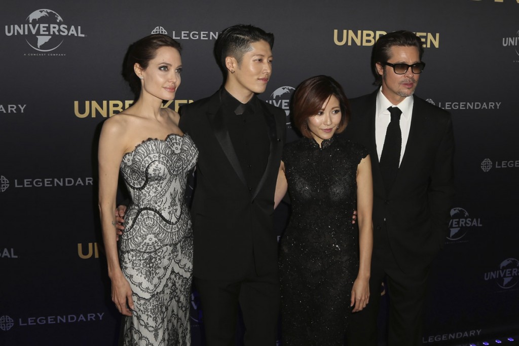 Movie star Angelina Jolie left, director of "Unbroken", poses for photos with Mayavi, second left, Melody Ishihara, center, and Brad Pitt, right, at the World Premiere of the film in Sydney, Australia Monday Nov. 17, 2014. (AP Photo/Glenn Nicholls)