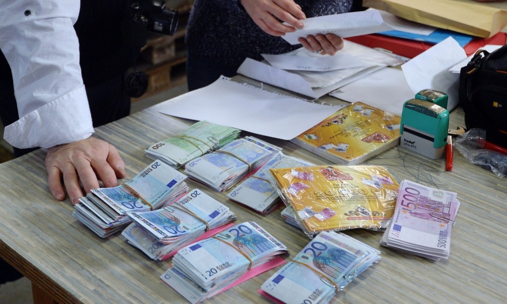 Employees prepare envelopes with banknotes during a secret operation in Saint-Avold, eastern France. (Source: Patrick Hertzog/AFP/Getty Images)