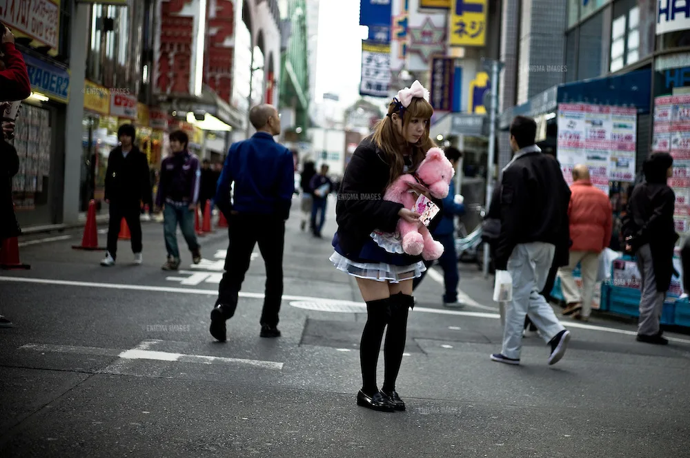 Maids & their cafes in the neon lit streets of Akihabara district of Tokyo, Japan. The Akihabara neighborhood is a popular gathering site for Otaku. (Source: enigmaimages.photoshelter.com)
