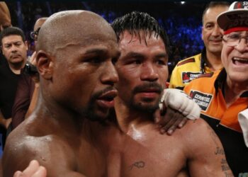 Floyd Mayweather Jr., left, hugs Manny Pacquiao after defeating him in their welterweight unification bout (Source: CNN)
