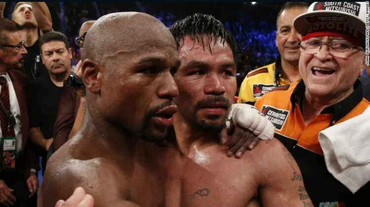 Floyd Mayweather Jr., left, hugs Manny Pacquiao after defeating him in their welterweight unification bout (Source: CNN)