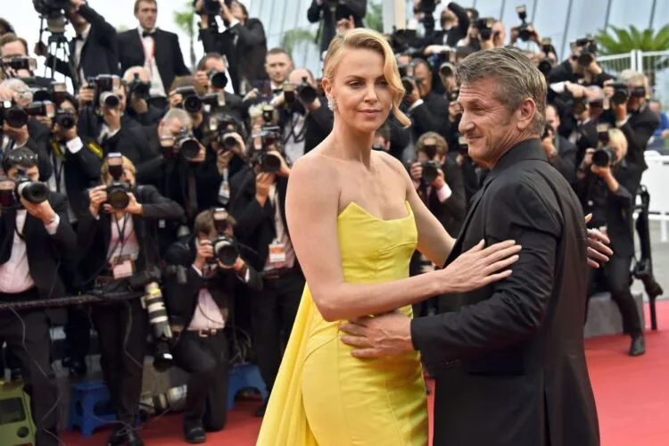 South African-US actress Charlize Theron (L) and her partner US actor Sean Penn pose as they arrive for the screening of the film "Mad Max : Fury Road" during the 68th Cannes Film Festival in Cannes, southeastern France, on May 14, 2015. AFP PHOTO / LOIC VENANCELOIC VENANCE/AFP/Getty Images ORIG FILE ID: 540670197