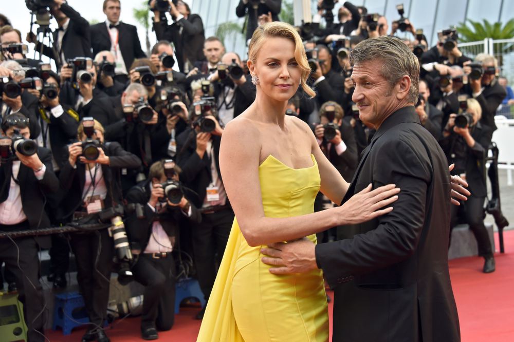 South African-US actress Charlize Theron (L) and her partner US actor Sean Penn pose as they arrive for the screening of the film "Mad Max : Fury Road" during the 68th Cannes Film Festival in Cannes, southeastern France, on May 14, 2015.    AFP PHOTO / LOIC VENANCELOIC VENANCE/AFP/Getty Images ORIG FILE ID: 540670197