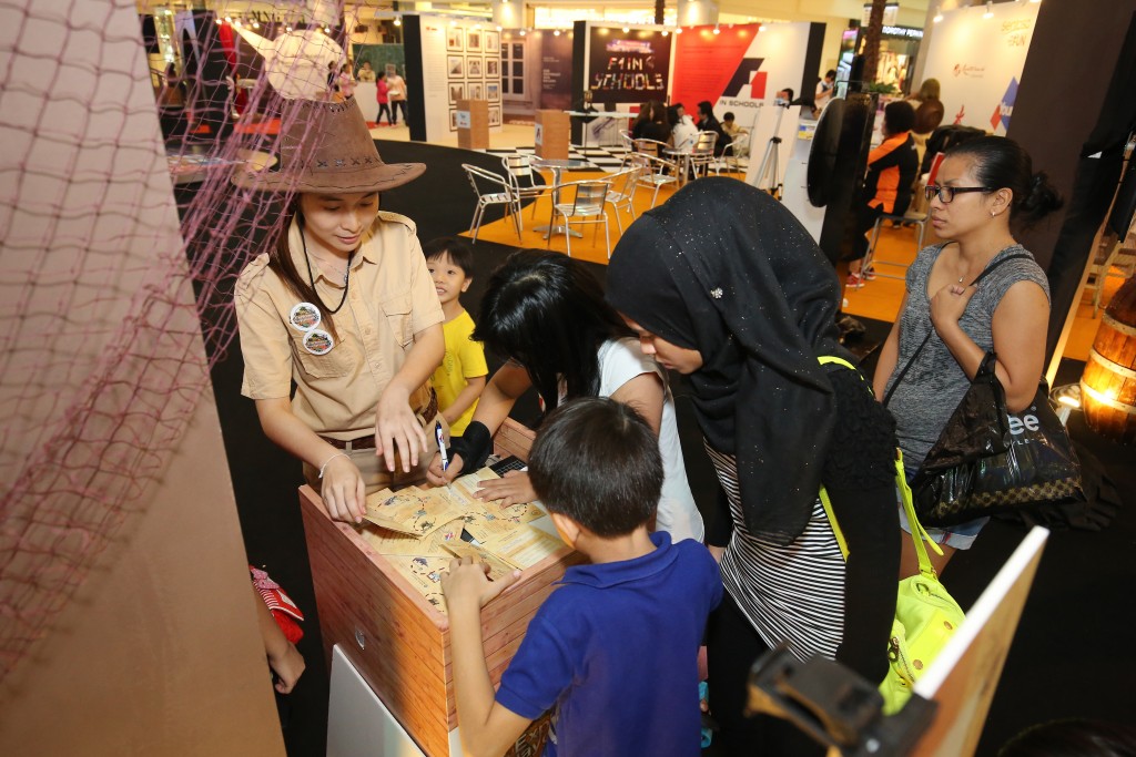 Parents and kids exciting signing up for the Explorer's Playground passport