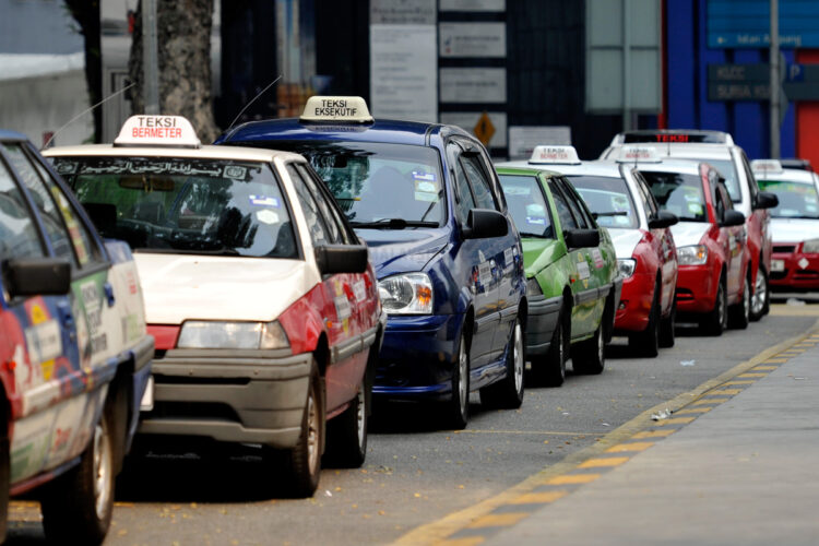 Taxis are parked as drivers wait for customers on a road in Kuala Lumpur on February 19, 2014. The Malaysian Insider/Najjua Zulkefli