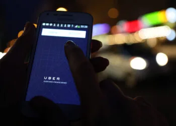 BERLIN, GERMANY - SEPTEMBER 02: In this photo illustration, a woman uses the Uber app on an Samsung smartphone on September 2, 2014 in Berlin, Germany. Uber, an app that allows passenger to buy rides from drivers who do not have taxi permits, has had its UberPop freelance driver service banned in Germany after a complaint by Taxi Deutschland, a trade association of taxi drivers in the country. The company, which operates in 42 countries over 200 cities worldwide, plans to both appeal the decision made by a court in Frankfurt as well as, at the risk of heavy fines, continue its services in Germany until a final decision has been made on the matter. (Photo by Adam Berry/Getty Images)