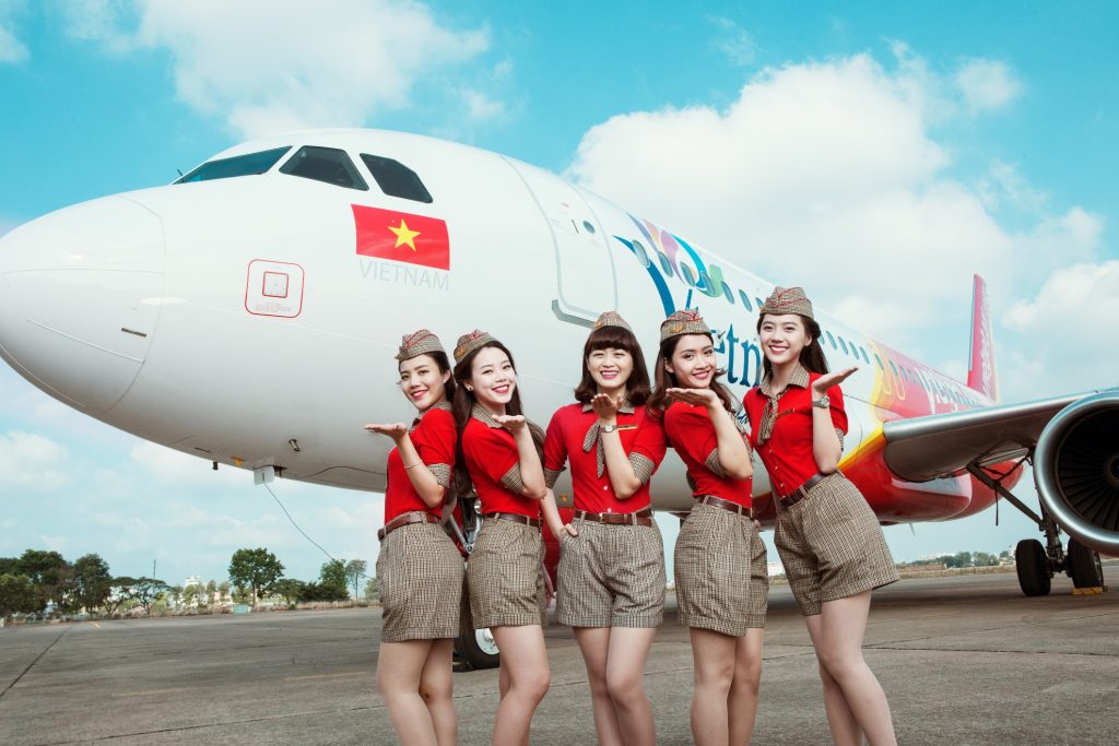Vietjet's Cabin Crew in front of the Vietnamese Tourism branded aircraft