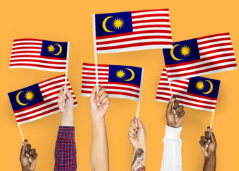 Hands waving flags of Malaysia