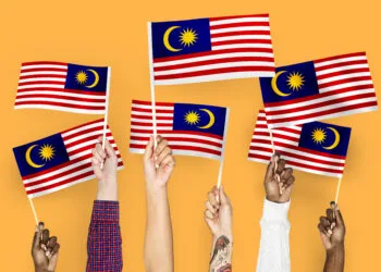 Hands waving flags of Malaysia