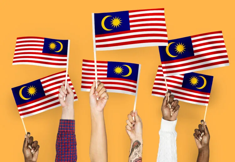 Hands waving flags of Malaysia