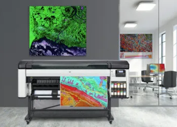 Dark gray office lobby with a concrete floor, loft windows and a glass wall. There is a large vertical poster and a meeting room. 3d rendering mock up; Shutterstock ID 763348642; Purchase Order: -