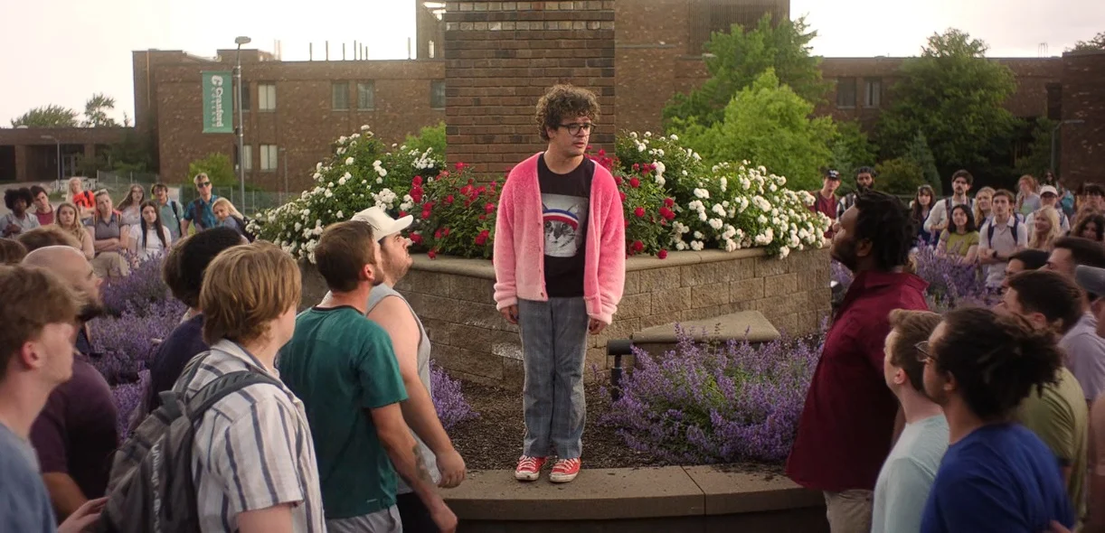Gaten Matarazzo stands up to the college crowd in "Pizza Movie"